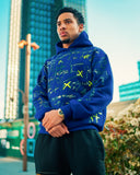 Model wearing the North Bioko Club Graffiti Hoodie in Cobalt Blue, three-quarter view with hand-painted artwork