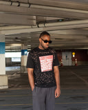 North Addiction black and red T-shirt worn in an urban parking garage setting