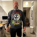 Customer wearing a charcoal North Bioko Club sweatshirt with colourful graffiti-style front artwork