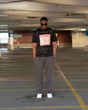 Full-body view of oversized North Bioko Club black T-shirt with red graphic print