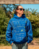 Front view of the North Bioko Club Graffiti Hoodie in Cobalt Blue with hand-painted all-over artwork