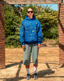 Full-length view of model wearing the Cobalt Blue North Bioko Graffiti Hoodie, showing the oversized boxy fit
