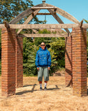 Model wearing the North Bioko Club Graffiti Hoodie in Cobalt Blue, full-body outdoor lifestyle view