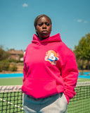 Model wearing the Hibiskus Pink Peach Hoodie with North Bioko baseball chest graphic and kangaroo pocket