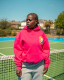Model wearing the North Bioko Club Peach Hoodie in Hibiskus Pink, showing the oversized dropped-shoulder fit